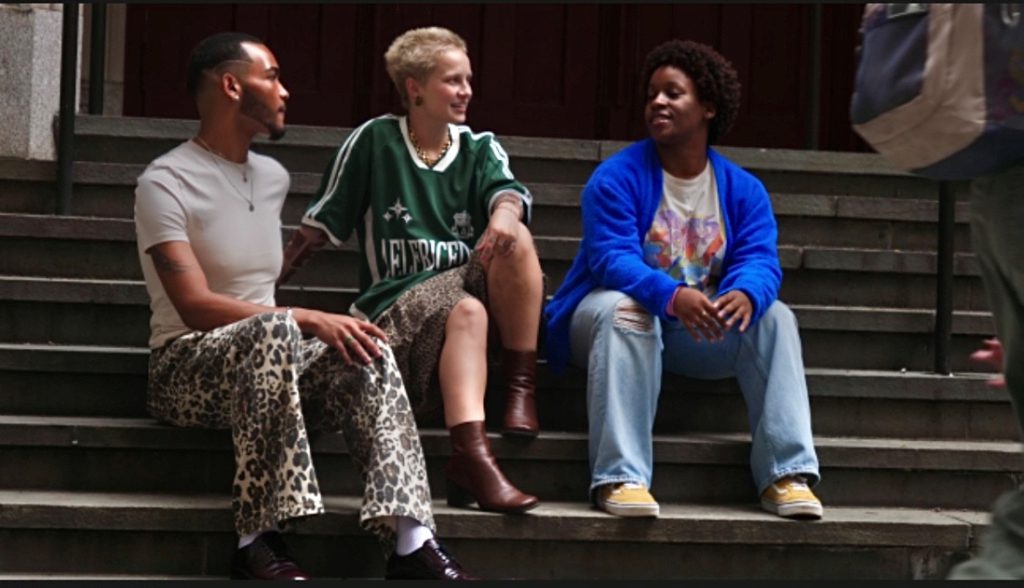 Chris Rodriguez (far left) Margaux McCarthy and Danika Murphy (far right) sitting on the stoops of Hunter College’s North Building Entrance. Photography by Maxwell Cane.