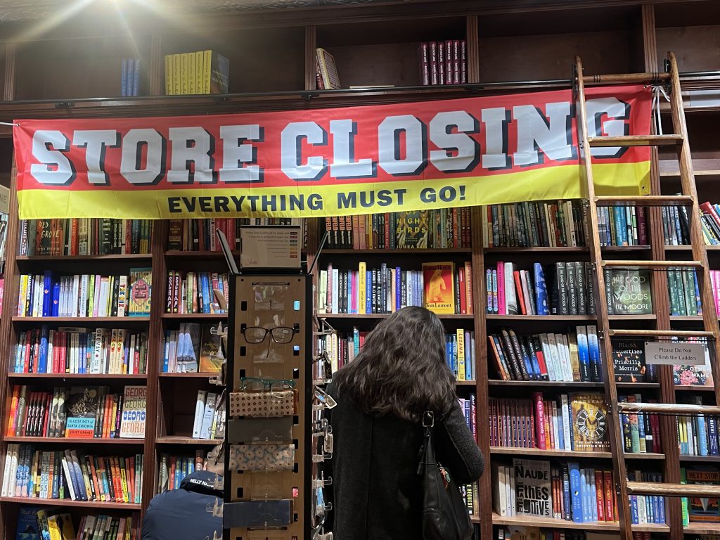 Store closing sign inside of Shakespeare &Co
