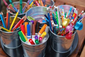 Photo of various art supplies in cans