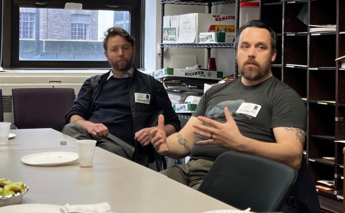 Two white men sit at a table