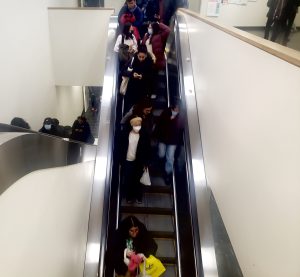 Students ride an escalator