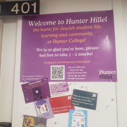 A purple sign reading "Welcome to the Hunter Hillel"