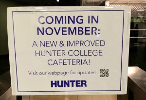 Sign announces the coming of the new cafeteria and the opportunity to name it.