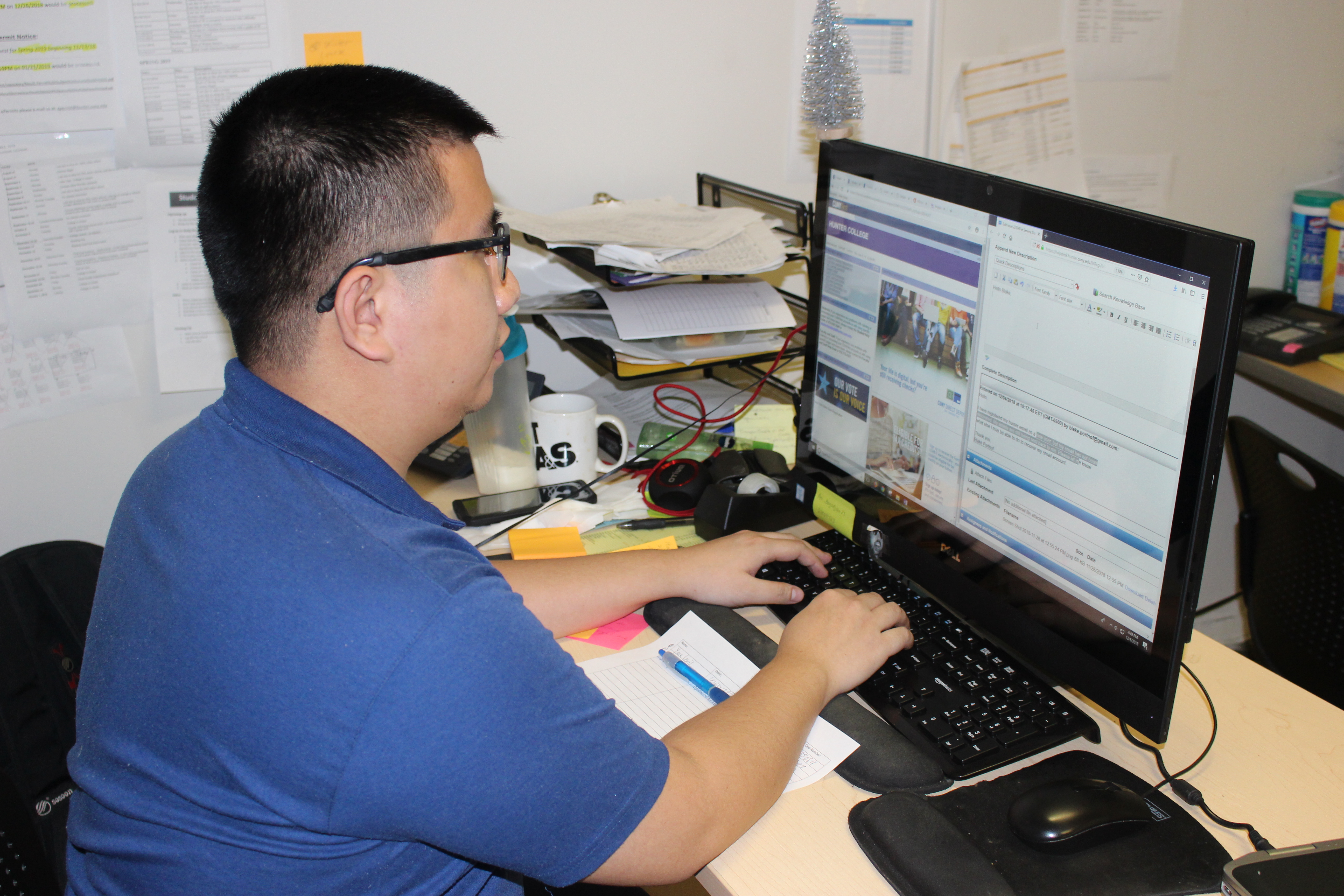 IT support assistant Vincent Wu at work in the IT Department's office, Room 303 Hunter North.