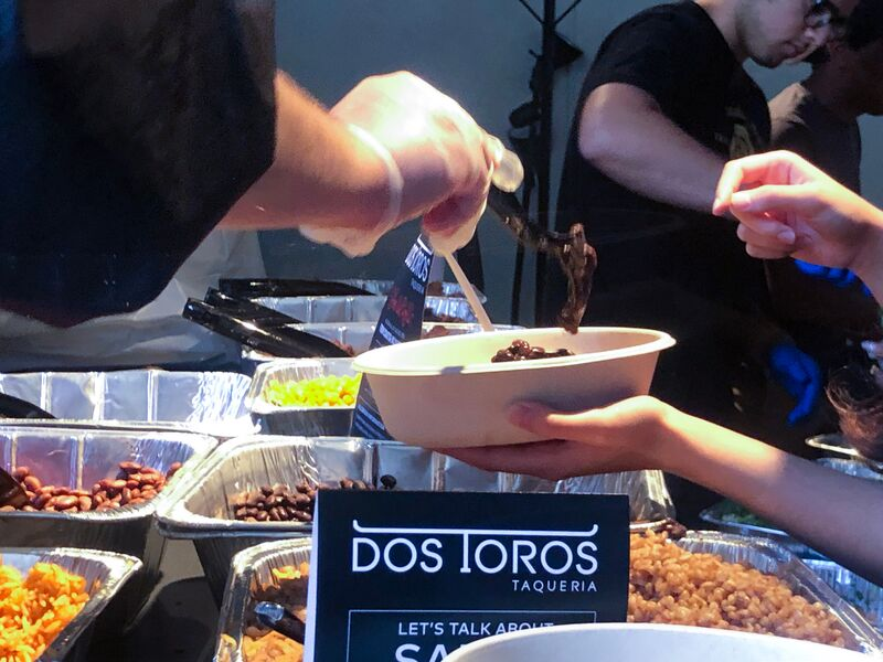 A USG representative fills a student's taco bowl during "30 in 30."