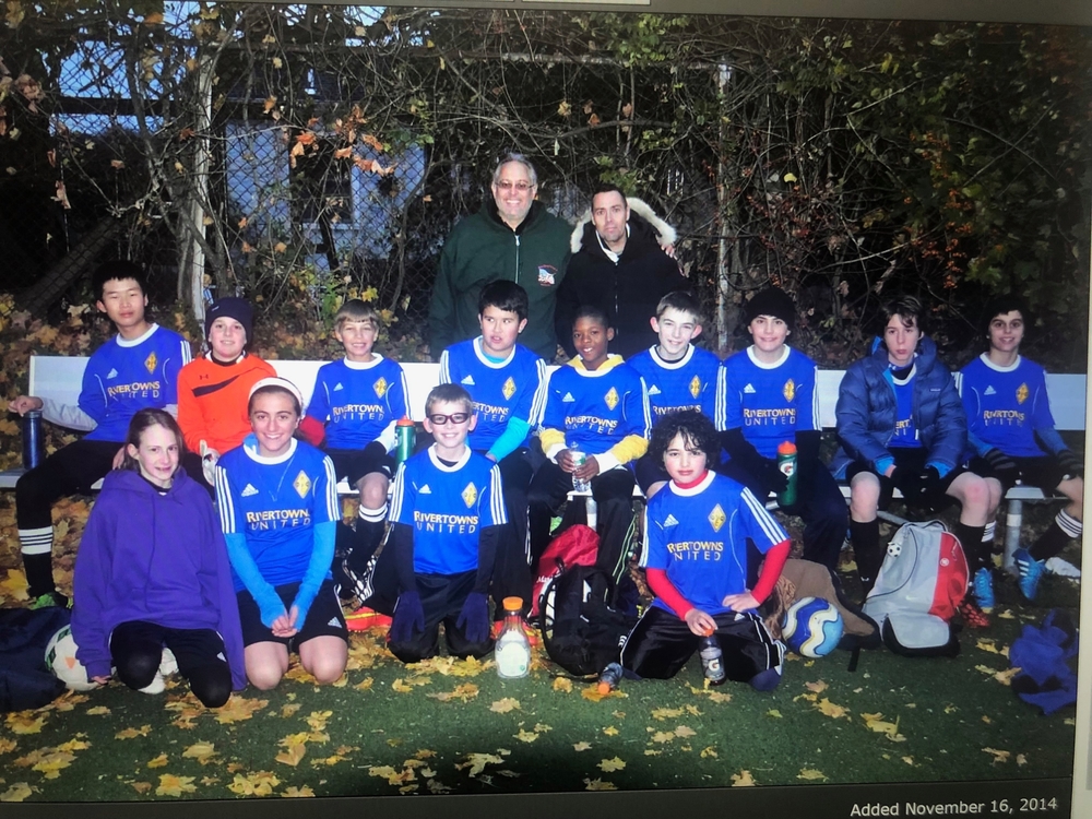 A group photo of the RUFC boy's club team. Abirizk and another girl are sitting in the lower left.