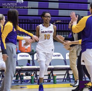 Ashley Arias high-fiving her teammates coming onto the court for her final home game