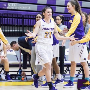 Christine Patterson high-fiving her teammates coming onto the court for her final home game