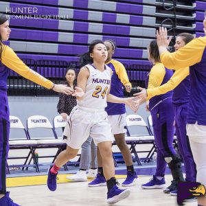 Selina Lim high-fiving her teammates coming onto the court for her final home game